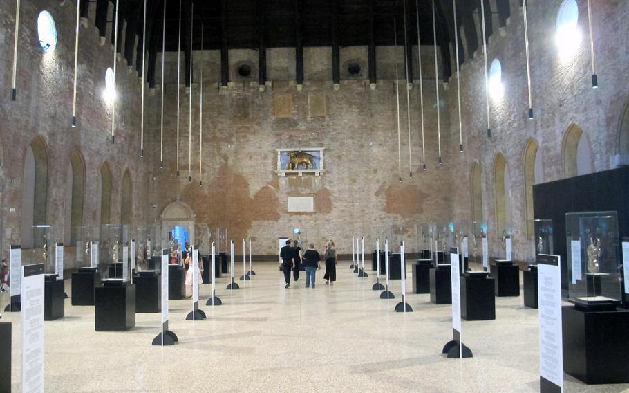 The vast hall in the Palladian Basilica shows an exhibit based on a medieval epic poem, July 6, 2021 in Vicenza, Italy. The exhibition, which runs through Aug. 31, is also expected to appeal to people interested in tattoo and street art.
