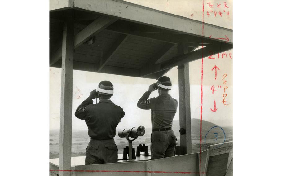 Two unidentified soldiers check for communist movements across the DMZ in North Korea at Outpost Maizie. OP Maizie was manned by the 1st Reconnaissance Squadron, 9th Cavalry Regiment, 1st Cavalry Division as one of several posts strung across the 18.5 miles of DMZ border. 