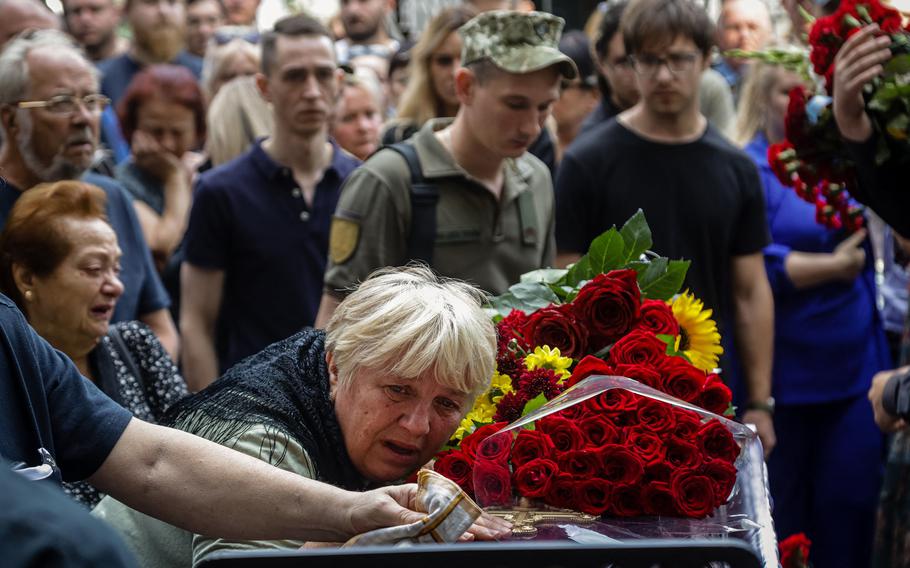 Family members mourn during a funeral, in the Black Sea port city of Odessa, in southern Ukraine on Sept. 2, 2022. 