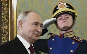 Russian President Vladimir Putin enters a room and is saluted.