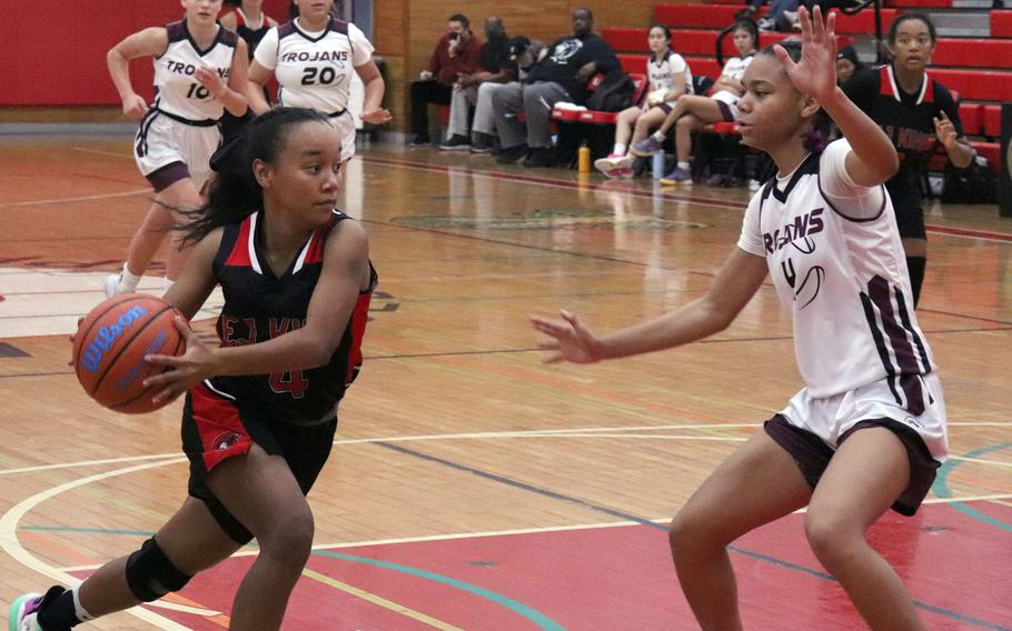 E.J. King's Moa Best drives against Zama's Naviah Blizzard during Saturday's DODEA-Japan girls basketball game. The Cobras won 70-56.