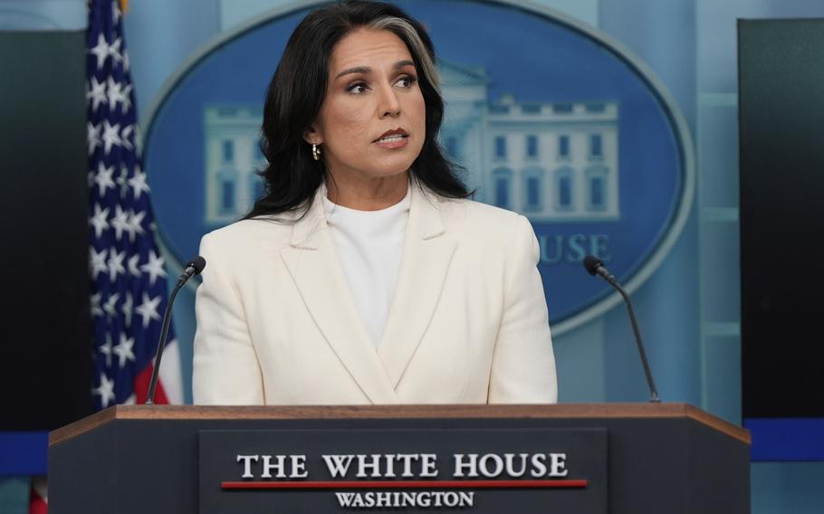 ODNI Director Tulsi Gabbard speaking in a White suit at the White House.
