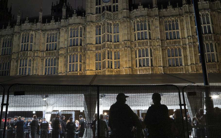 People move through a security checkpoint before entering Westminster Hall to see the coffin of Queen Elizabeth II. 