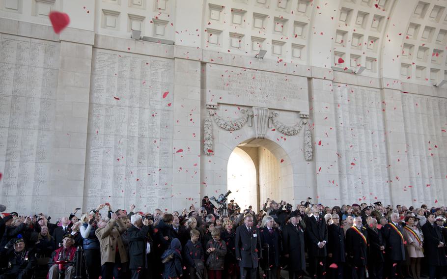 Red paper poppies fall from the ceiling during an Armistice Day ceremony at the Menin Gate in Ypres, Belgium, on Tuesday, Nov. 11, 2014. Since the end of World War I in 1918, millions of visitors have flocked to memorials in northern France and Belgium to pay tribute to the fallen. 