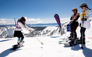 Skiers snow golfing at the Palisades Tahoe resort. 