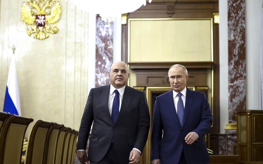 Russian President Vladimir Putin, right, escorted by Russian Prime Minister Mikhail Mishustin arrives for a meeting with Cabinet members in Moscow, Russia, Monday, May 6, 2024. Putin thanked Cabinet ministers for their work ahead of his inauguration Tuesday. 