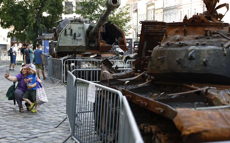 Members of the public look around some destroyed Russian tanks in the city center in Lviv, Ukraine, on Aug. 22, 2022.