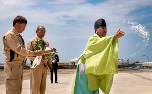 A Shinto priest performs a purification ritual with salt and sake for the 33rd Rescue Squadron's new hangar at Kadena Air Base, Okinawa, April 17, 2024.