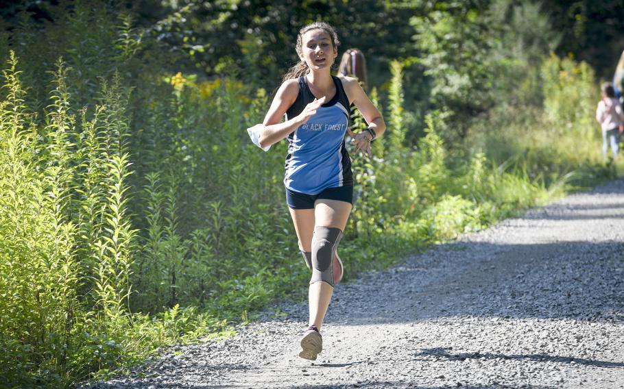 Naomi Boyd, a runner at Black Forest Academy, dashes down the final stretch of a high school girls’ varsity cross country meet Saturday, Sept. 18, 2021, in Kaiserslautern, Germany.