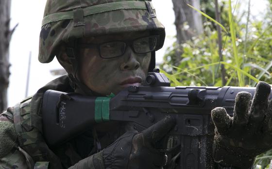 A Japan Ground Self-Defense Force soldier works security alongside U.S. Marines during a beach raid exercise in Kin, Okinawa, Feb. 9, 2020.