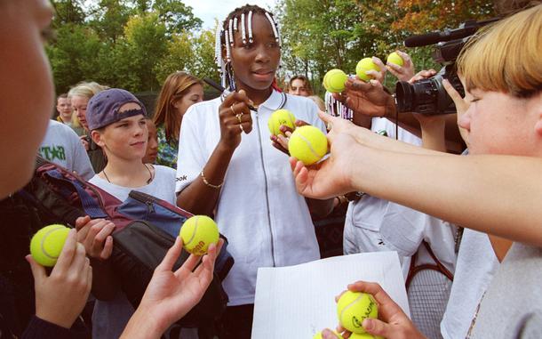 Hed: Venus Williams at Patch High School, 1997

Stuttgart, Germany, Oct. 7, 1997: Teenage tennis star Venus Williams signs autographs for the students of Patch High School. The powerful player was very generous with her time, giving several interviews, answering questions in a special student session, handing out tennis advice and autographing everything handed to her. 
To top it all off, Venus, and her sister Serena took to the tennis court with Patch's tennis team for a few back and forths, occasionally stopping to make a suggestion. 

Looking for Stars and Stripes’ historic coverage? Subscribe to Stars and Stripes’ historic newspaper archive! We have digitized our 1948-1999 European and Pacific editions, as well as several of our WWII editions and made them available online through https://starsandstripes.newspaperarchive.com/

META TAGS: Tennis; sports; 