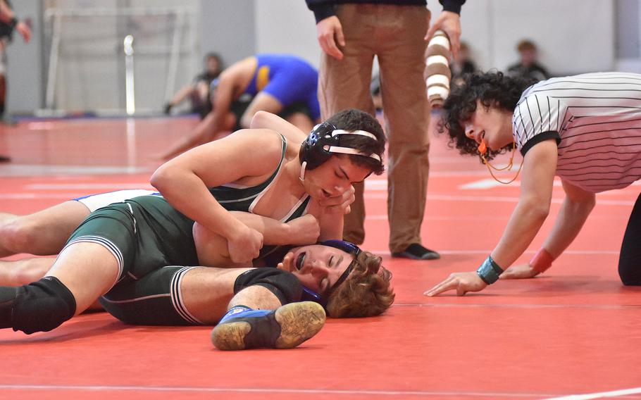 Rota's Daniel Guido is down but not out in a 165-pound match against Naples' Triston Roebuck on Saturday, Feb. 4, 2023, at the DODEA-Europe Southern Europe regional at Aviano Air Base, Italy. Guido went on to win the match.