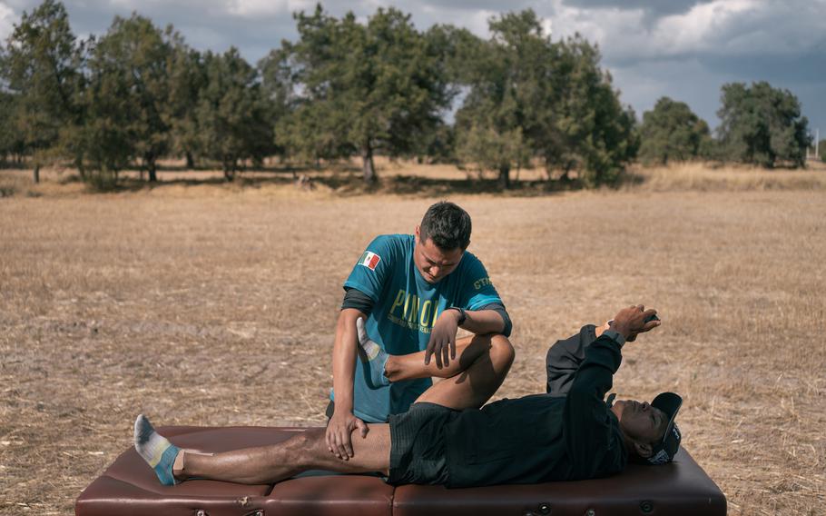 Physiotherapist Luis Francisco Corona Jaramillo stretches German Silva during a break in Tlaxcala. 
