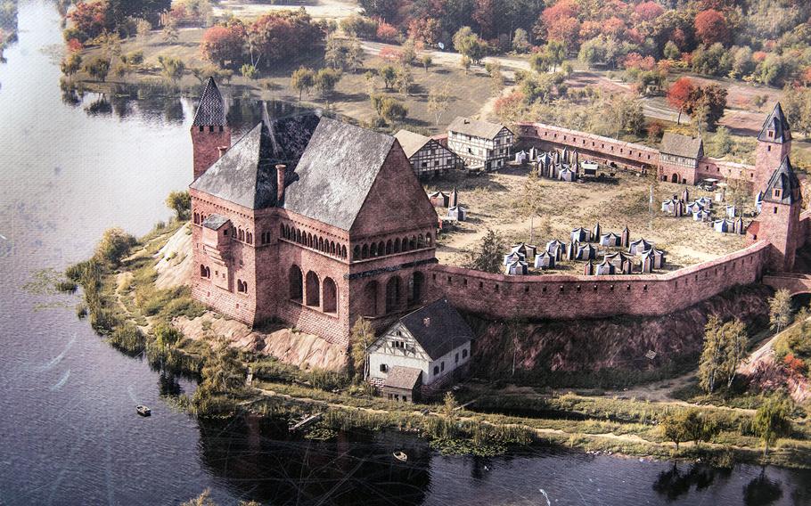 An illustration of what Emperor Frederick Is Imperial Palace might have looked like is displayed in downtown Kaiserslautern on Saturday, Nov. 5, 2022, next to where the palace once stood. Today, the river and pond have been replaced by concrete streets and shops, and the palace has been partially reconstructed.