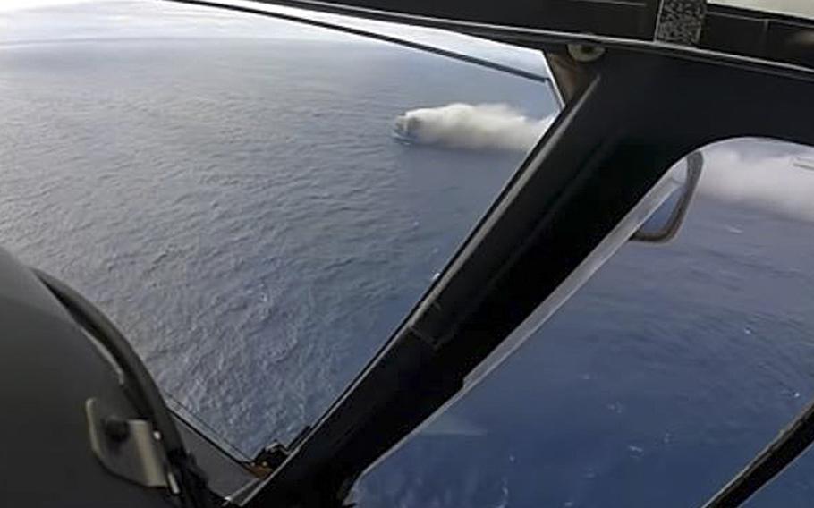 A screen grab from a video posted Feb. 17, 2022, shows a burning cargo ship in the distance. On Feb. 16, 22 crew members from the merchant ship Felicity Ace were rescued after a fire broke out in the vessel’s cargo hold.  