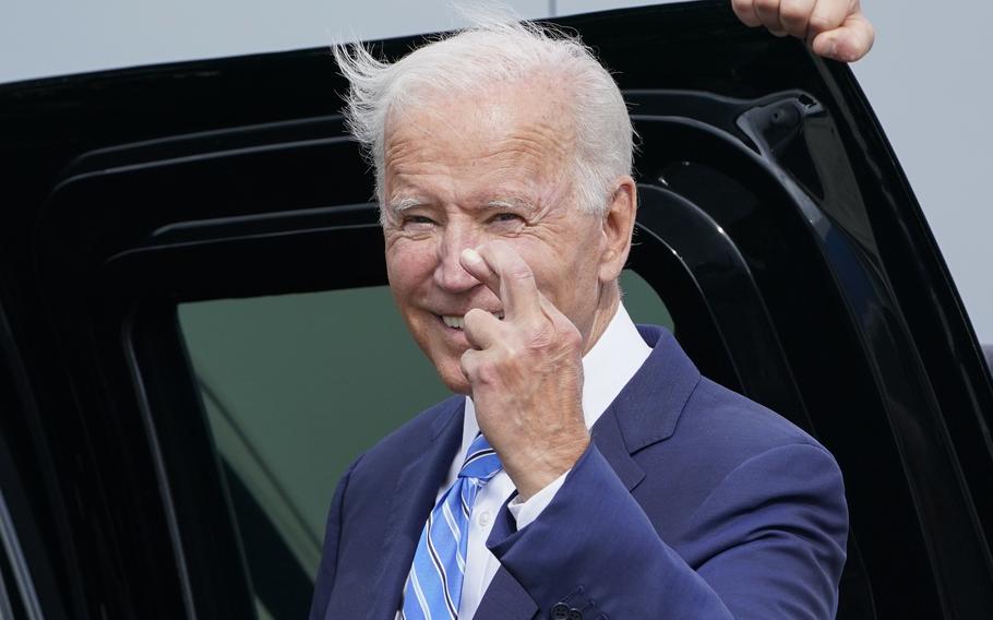 President Joe Biden crosses his fingers as he responds to a question about the short term debt deal as he arrives Air Force One at O’Hare International Airport in Chicago, Thursday, Oct. 7, 2021. While in the Chicago area, Biden will highlight his order to require large employers to mandate COVID-19 vaccines for its workers during a visit to a construction site. 