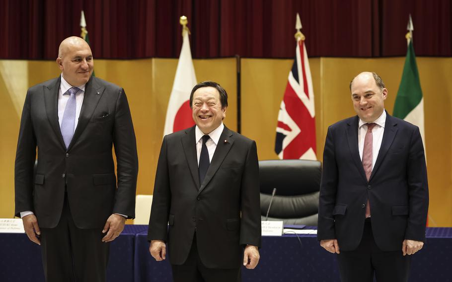 Britain’s Defense Minister Ben Wallace, right, Italy’s Defense Minister Guido Crosetto, left, and Japan’s Defense Minister Yasukazu Hamada pose for a photo before their trilateral meeting Thursday, March 16, 2023 in Tokyo, Japan.  