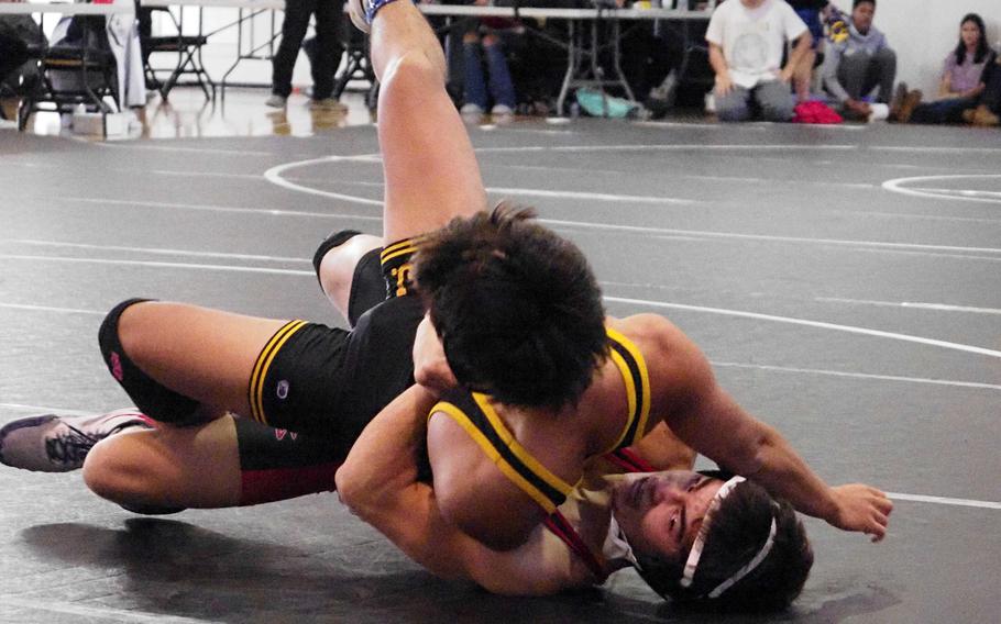 Nile C. Kinnick 139-pounder Joseph Mauldin gut-wrenches American School In Japan’s Gabe Shikuma in the Zama Invitational Tournament. Mauldin won the weight-class title.