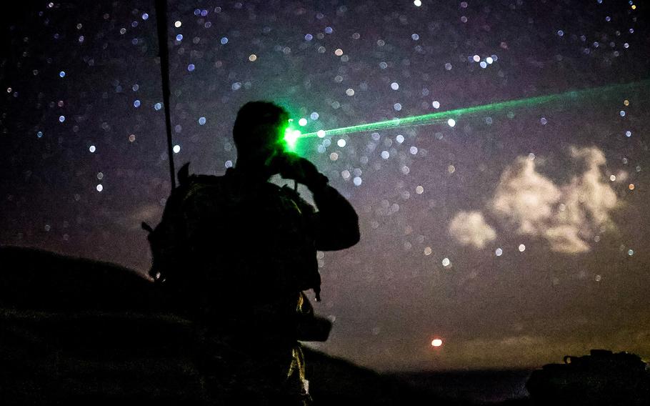 A soldier stands at an observation post at Makua Valley in Waianae, Hawaii on April, 15, 2021, as units were conducting Artillery Air Assault call for fire, and other key training tasks to hone their craft. 