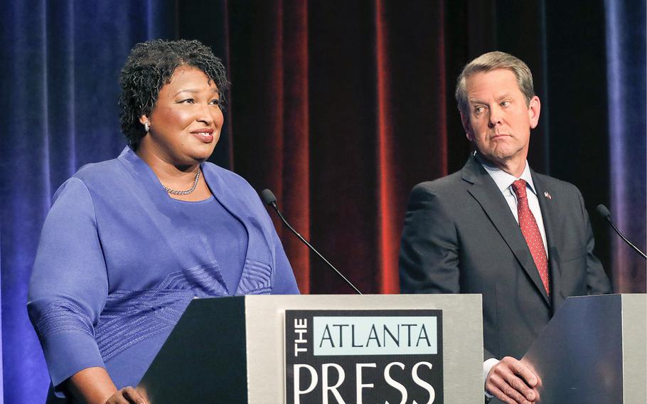 Then-Democratic gubernatorial candidate for Georgia Stacey Abrams, left, speaks as her Republican opponent Secretary of State Brian Kemp looks on during a debate in Atlanta on Oct. 23, 2018. A federal judge ruled on Friday, Sept. 30, 2022, ruled against Abrams’ lawsuit against Georgia’s election laws.