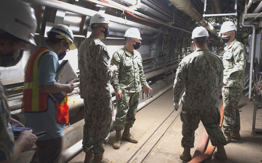 Rear Adm. John Korka, head of Naval Facilities Engineering Systems Command, center, speaks with Navy leaders about the water quality recovery effort during a visit to the Red Hill Bulk Fuel Storage Facility Dec. 23, 2021.