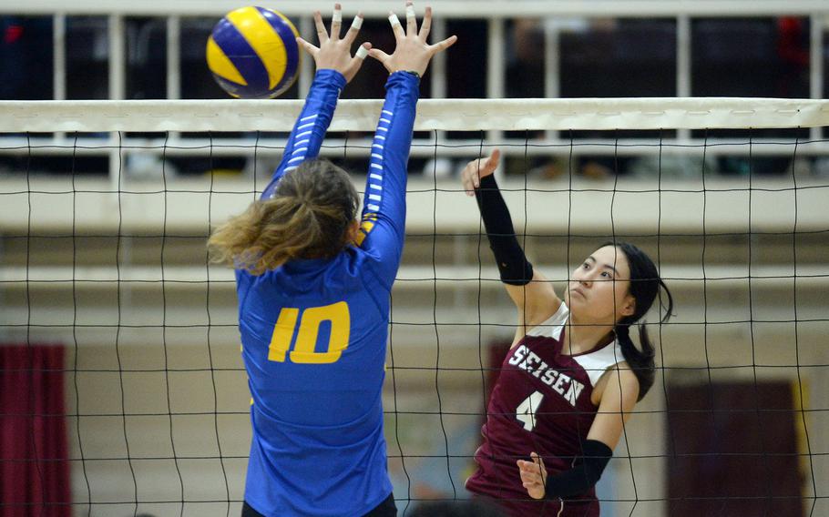 Seisen's Maya Hemmi spikes past Yokota's Lucy Wellons during Tuesday's Kanto Plain volleyball match. The host Phoenix won in three sets.