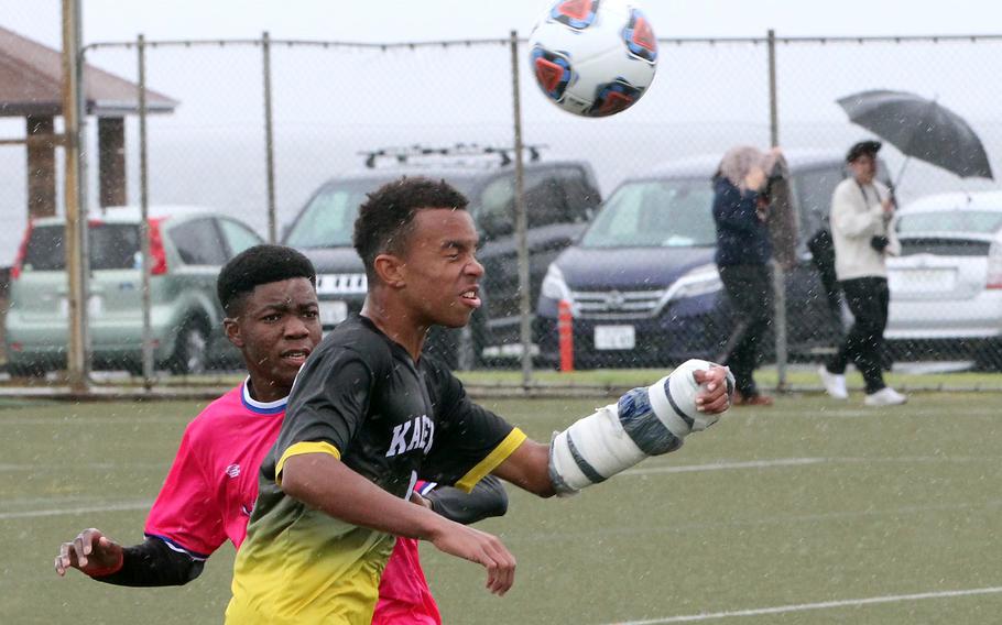 Kadena's Elijah Whipp heads the ball in front of Nile C. Kinnick's Leon Awesso.