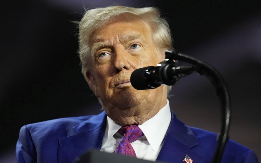 Close-up view of Donald Trump behind a microphone.