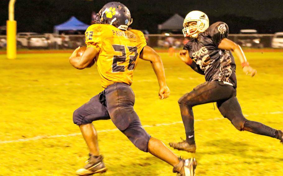 Guam High's DeShawn Baird races for the end zone against Alika Farell of Simon Sanchez.