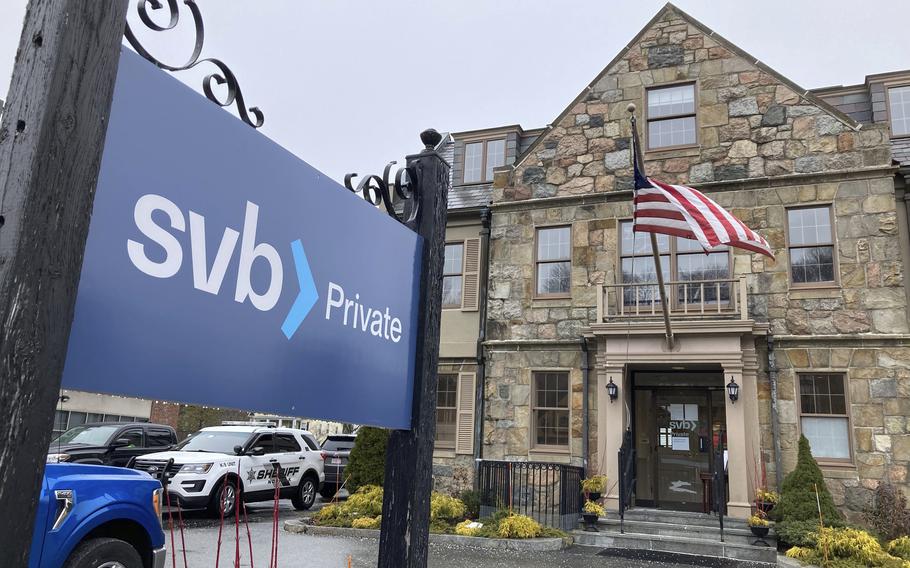 Vehicles are parked outside a Silicon Valley Bank branch in Wellesley, Mass., on Saturday, March 11, 2023.  Regulators have seized the assets of one of Silicon Valley’s top banks, marking the largest failure of a U.S. financial institution since the height of the financial crisis almost 15 years ago.
