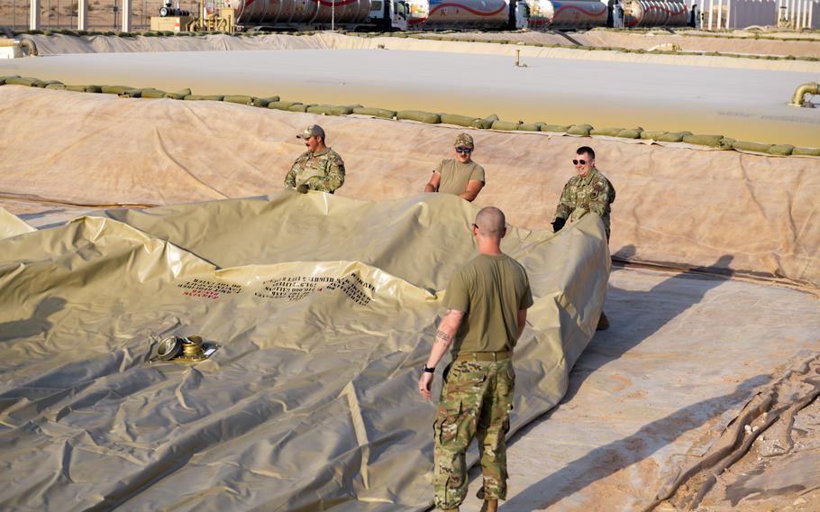 Air Force Brig. Gen. William Betts, the commander of the 378th Air Expeditionary Wing, and petroleum, oil and lubricants airmen assigned to the 378th Expeditionary Logistics Readiness Squadron drag a fuel bladder into place Sept. 6, 2022, at Bettsat Prince Sultan Air Base, Kingdom of Saudi Arabia.