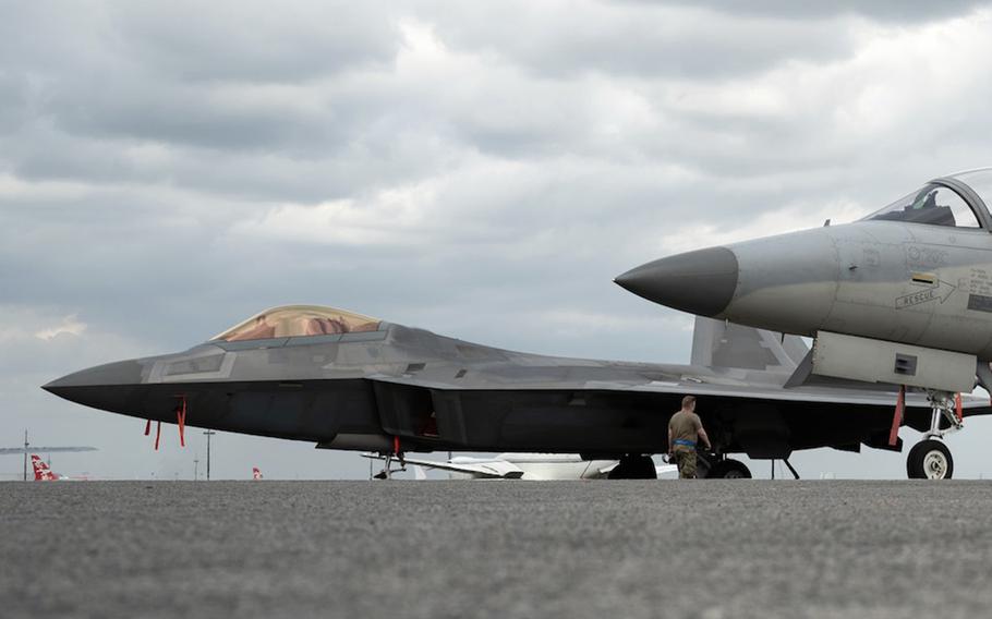 An Air Force F-22 Raptor, left, parks beside another jet at Clark Air Base, Philippines, in this photo tweeted by the. U.S. Embassy, Thursday, March 16, 2023.