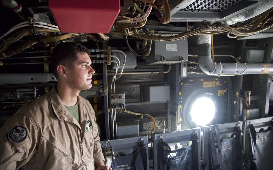 U.S. Marine Corps Sgt. William Kennedy, a weapons and tactics instructor and MV-22 Osprey crew chief deployed to Camp Lemonnier, Djibouti, discusses his duties in the cargo bay of a hot Osprey on a runway, Oct. 27, 2021.