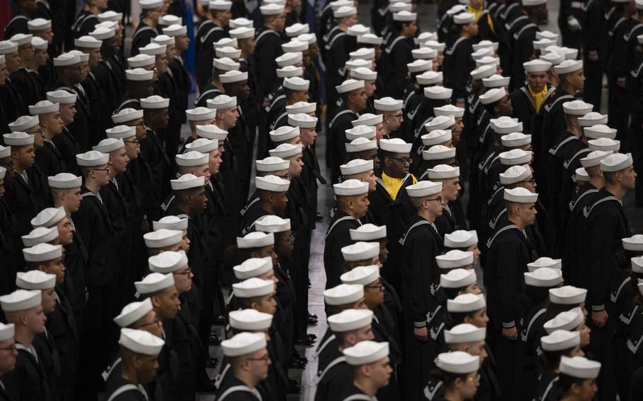 Recruits stand at attention in November 2022 during a graduation ceremony at Naval Station Great Lakes, Ill.