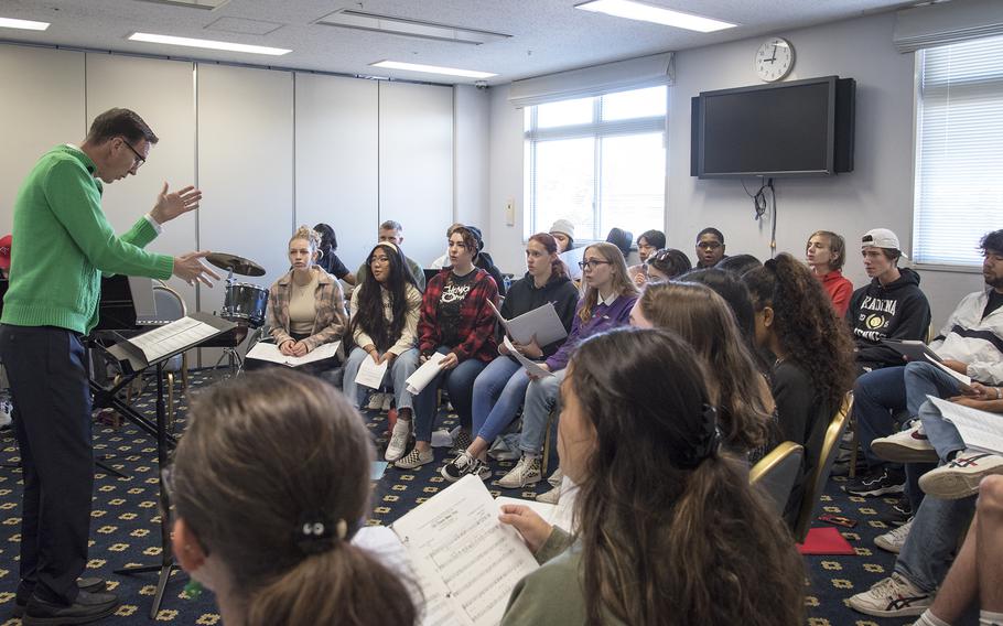 Scott Morrise, a music teacher at Sollars Elementary School, Misawa Air Base, directs the jazz choir as they rehearse at the Taiyo Community Center at Yokota Air Base, Japan, on Nov. 16, 2022. 