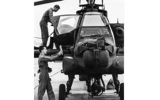 Chief Warrant Officer 2 Paul R. Stein (top) and Chief Warrant Officer 2 David M. Conboy perform a pre-flight inspection of their Apache helicopter before departing for the Middle East by way of Italy.
Gus Schuettler, Stars and Stripes
Wiesbaden, Germany, August 30, 1990