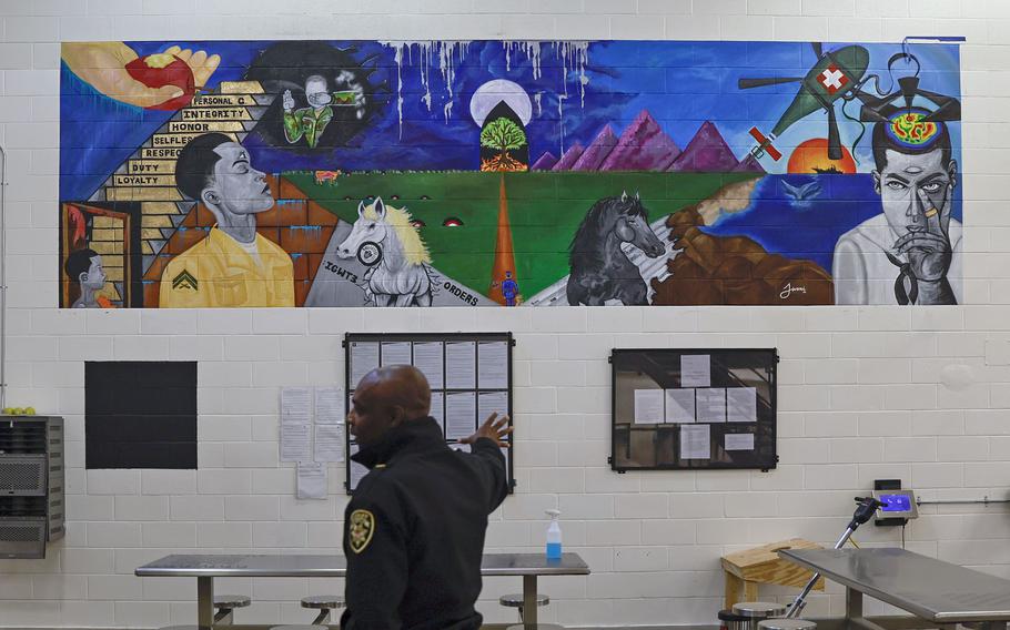 Col. Temetris Atkins, commander at Cobb County Detention Center, stands in front of a mural inside the veterans pod in the compliance dorms on Wednesday, November 2, 2022. 