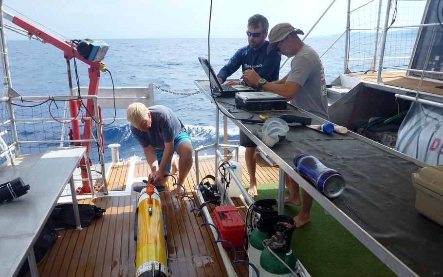 Project Recover cofounder Mark Moline rinses an underwater autonomous vehicle after its survey in waters off Croatia, Aug. 2, 2022.