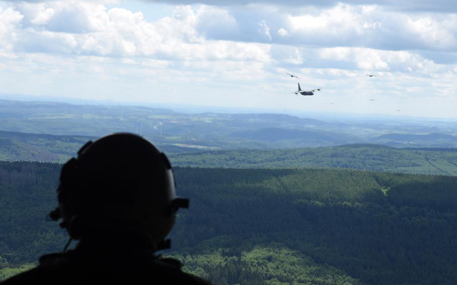 Several C-130J Super Hercules can be seen trailing in the distance from the open ramp of another C-130J on May 25, 2022, near Ramstein Air Base, Germany. Nine C-130Js with the 37th Airlift Squadron at Ramstein flew a training formation to mark the squadron’s 80th anniversary.