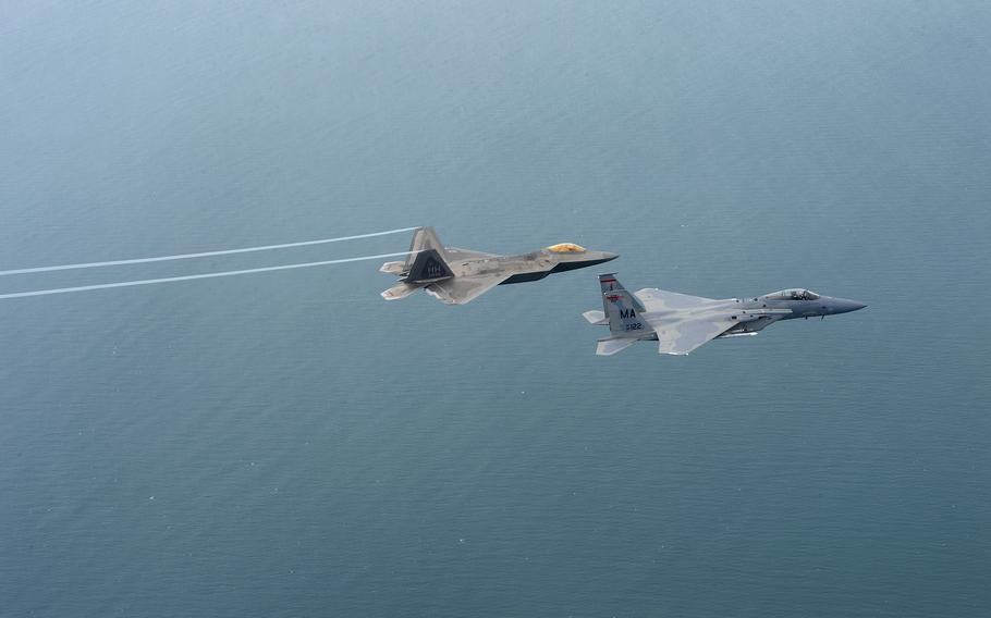 A U.S. Air Force F-22 Raptor from the 154th Wing, Joint Base Pearl Harbor-Hickam, Hawaii, and U.S. Air Force F-15 Eagle from the 131st Fighter Squadron, 104th Fighter Wing, Barnes Air National Guard Base, Mass., fly over Penang, Malaysia, during Cope Taufan 14, June 16, 2014. Members of Air National Guard’s 104th Fighter Wing from Westfield-Barnes Regional Airport assisted in shooting down a suspected Chinese spy balloon off the coast of South Carolina, Saturday, Feb. 4, 2023.