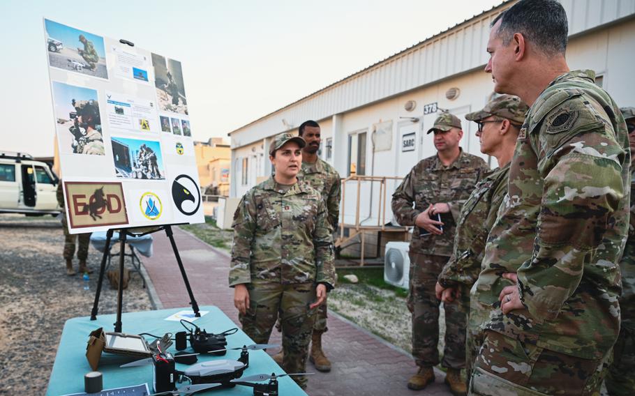 Air Force Lt. Gen. Alexus Grynkewich, commander of the Ninth Air Force (Air Forces Central), learns about one of the projects of Task Force 99 on Dec. 11, 2022, from Capt. Ana Smith of the 386th Expeditionary Civil Engineer Squadron, Explosive Ordnance Disposal, at Ali Al Salem Air Base, Kuwait.