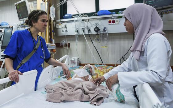 Pediatrician Tanya Haj-Hassan, left, examines a wounded child at Al-Aqsa Martyrs Hospital in Deir al-Balah, central Gaza, on March 16, 2024.