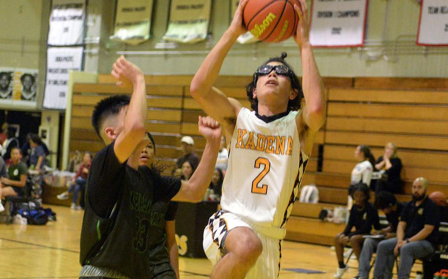Kadena's Angel Torrado puts up a shot against Kubasaki's Ryan Hater during Friday's DODEA-Okinawa boys basketball game. The Panthers won 58-29, improving to 3-0 against the Dragons this season.