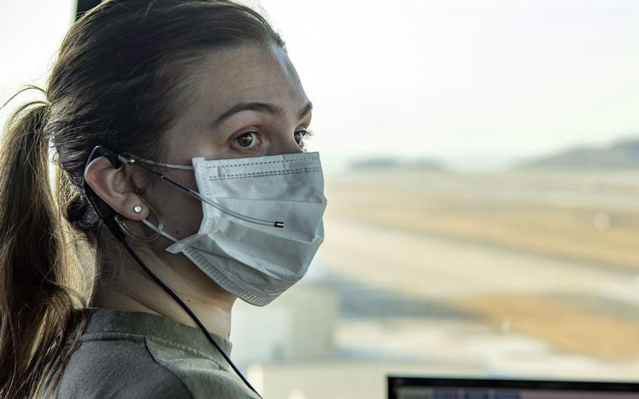 Senior Airman Abigail Kerr, an air traffic controller with the 8th Operations Support Squadron, communicates with fighter pilots performing low approaches at Kunsan Air Base, South Korea, Feb. 3, 2022. 
