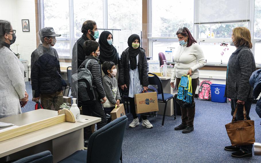 Abdul Wahid Qanit and his wife, Palwasha Qanit, register their children for school at a student registration welcome center for Fairfax County Public Schools. 
