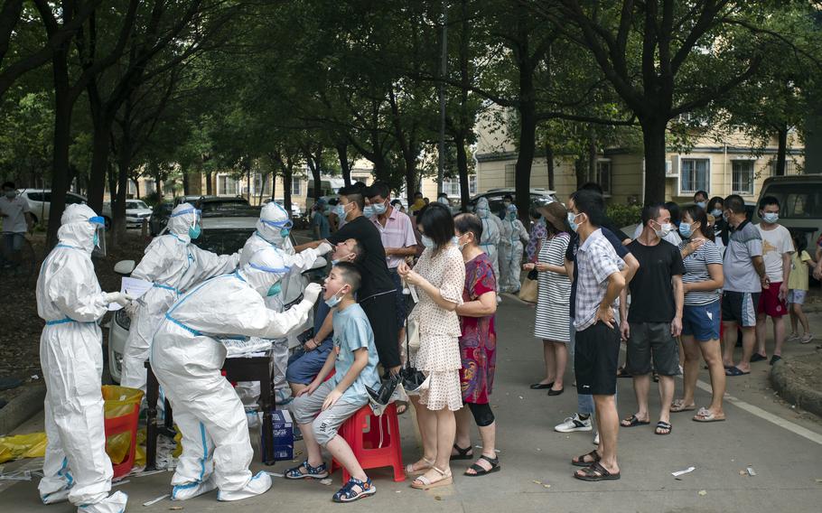 Residents line up to be tested for COVID-19 in Wuhan, central China's Hubei province on Aug. 3, 2021.