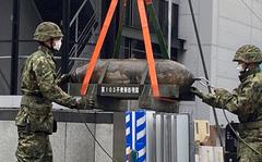 Troops from the Japan Ground Self-Defense Force defuse a 550-pound bomb, believed to be American-made from World War II, near Nagoya Station on Sunday, April 24, 2022.
