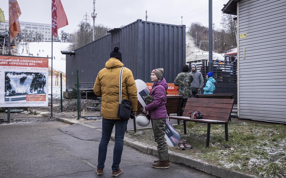 Daria Nadolgo holds her snowboard at Protasiv Yar, a ski complex close to downtown Kyiv.