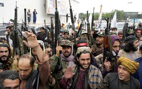 Taliban fighters celebrate one year since they seized the Afghan capital, Kabul, in front of the U.S. Embassy in Kabul, Afghanistan, Monday, Aug. 15, 2022. 