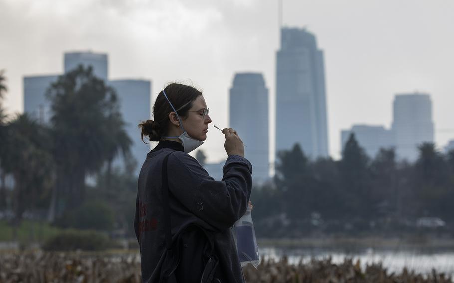 Lyndsey Marko takes a free PCR COVID-19 test in Los Angeles on Tuesday, Jan. 18, 2022.